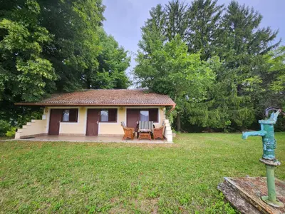 a small house with a picnic table in a yard at Hiša Heidi in Zavrč