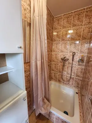 a bathroom with a shower with a shower curtain at Hiša Heidi in Zavrč
