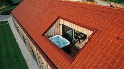 an overhead view of a building with an open window at Štajerska sivka - Jacuzzi & Savna in Maribor