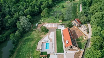 an aerial view of a house with a river at Štajerska sivka - Jacuzzi & Savna in Maribor