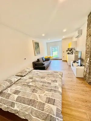 a bedroom with a large bed and a couch at Apilandia Nanos in Vipava