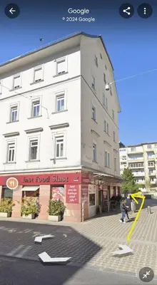 a large white building on a city street at Little Plaza Duplex in Ljubljana