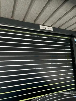 a metal garage door with a sign on top of it at AURORA Apartment Banovci in Banovci
