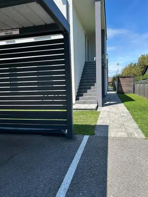 a garage door on the side of a house at AURORA Apartment Banovci in Banovci