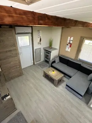 an overhead view of a living room with a couch and a table at Močvirski Tulipan in Ljubljana