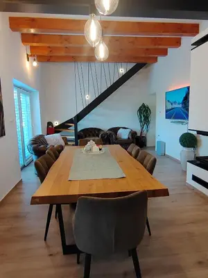 a living room with a wooden table and a couch at Hiška pri brajdah in Videm pri Ptuju
