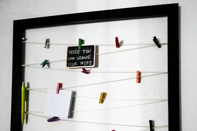 a wall with clothes pins and a sign on it at Apartma Cave Bliss Maribor in Maribor