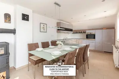 a kitchen with a table and chairs in a kitchen at Hiša Oder in Woditz