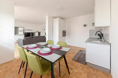 a kitchen and dining room with a table and chairs at Hiša Oder in Woditz