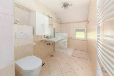 a bathroom with a toilet and a sink at Hiša Oder in Woditz