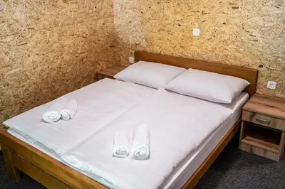 a bed with two pairs of slippers on it at Ribnik Stari trg in Lesično
