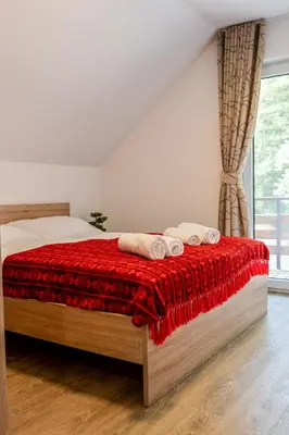 a bedroom with a bed with two towels on it at Ribnik Stari trg in Lesično