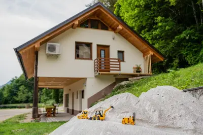 a house with three toy tractors in front of it at Ribnik Stari trg in Lesično