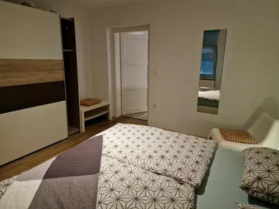 a bedroom with a bed and a mirror at Apartment Lublana in Ljubljana