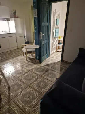 a living room with a table and a kitchen at Apartment Lublana in Ljubljana
