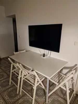 a white table with a television on top of it at Apartment Lublana in Ljubljana