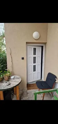 a patio with a door and a chair and a table at Apartment Lublana in Ljubljana