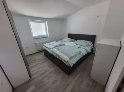 a small bedroom with a bed and a window at Jack apartments in Maribor