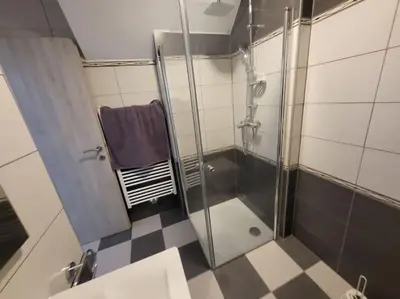 a shower with a glass door in a bathroom at Jack apartments in Maribor