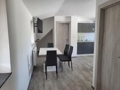 a kitchen and dining room with a table and chairs at Jack apartments in Maribor