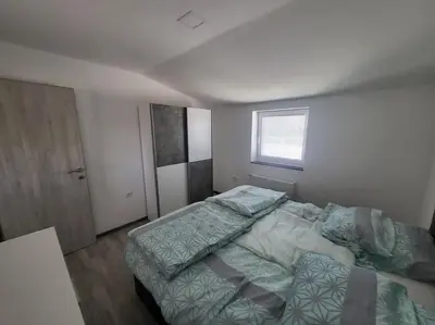 a bedroom with a bed and a window at Jack apartments in Maribor