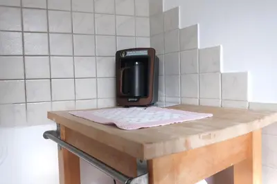 a phone sitting on top of a wooden table at Apartment Maya in Kranjska Gora