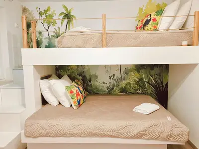twolevel bunk beds in a room with a pillow at Dream home apartment in Koper