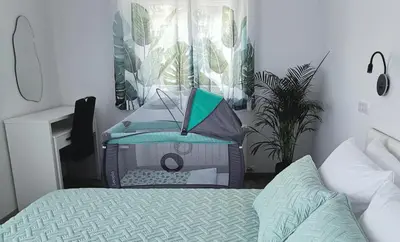 a bedroom with a bed with a laptop on it at Dream home apartment in Koper
