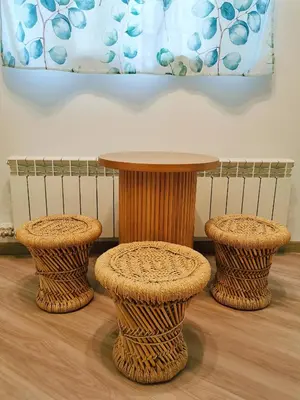 a table and two stools in a room at Dream home apartment in Koper