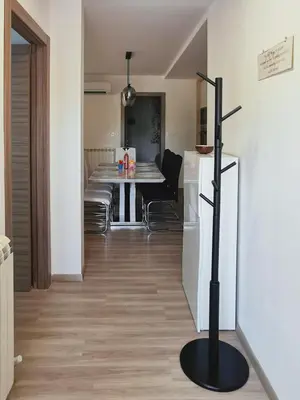 a kitchen and dining room with a table and a black pole at Dream home apartment in Koper