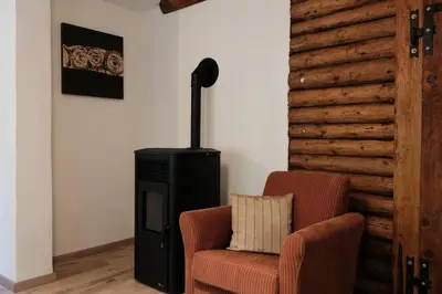 a living room with a chair and a heater at Juaniz in Tolmin