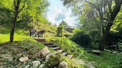 a set of stairs in a park with two chairs at Juaniz in Tolmin
