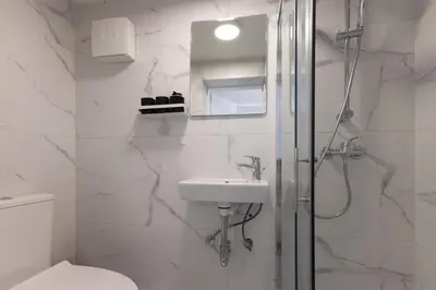 a bathroom with a shower and a sink and a toilet at Apartments Lia in Ljubljana