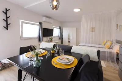 a living room with a dining table and a couch at Apartments Lia in Ljubljana
