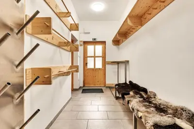a room with a row of benches and a door at Chalet Vitranc in Kranjska Gora