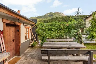 a wooden table and benches on a patio at Chalet Vitranc in Kranjska Gora