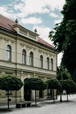 a large building with trees in front of it at Villa Elizabeth - Family Apartment for 6 in Slovenj Gradec