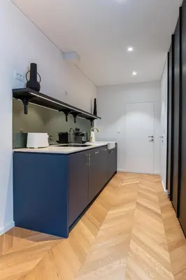 a kitchen with a blue counter and a wooden floor at Villa Elizabeth - Family Apartment for 6 in Slovenj Gradec