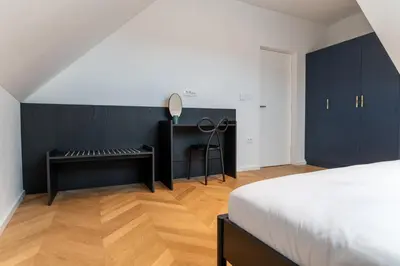 a bedroom with a desk and a bed and a desk at Villa Elizabeth - Family Apartment for 6 in Slovenj Gradec