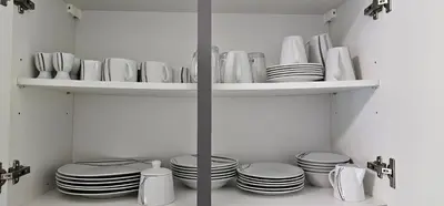 a shelf filled with plates and bowls and dishes at Apartma Marija in Kranjska Gora