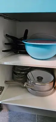 a shelf with a bowl and plates and pans at Apartma Marija in Kranjska Gora