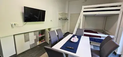 a room with a dining table and a bunk bed at Apartma Marija in Kranjska Gora