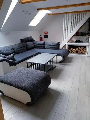 a living room with a couch and a table at Apartment Loft Pejić - open space loft studio near Bovec, Soča Valley in Bovec