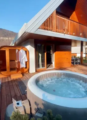 a hot tub in front of a house at Lux Chalet - Sauna and Hot Tub in Topolšica