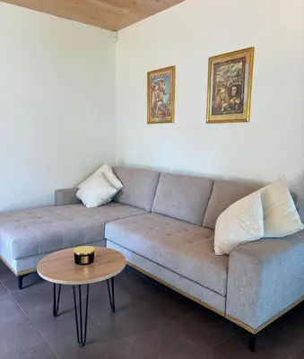 a living room with a couch and a table at Lux Chalet - Sauna and Hot Tub in Topolšica