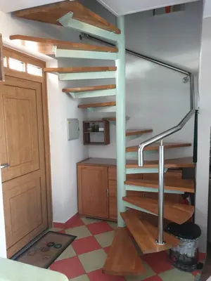 a spiral staircase in a room with a door at Marjetica20 in Moravske Toplice