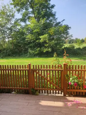 a wooden fence with flowers in a park at Marjetica20 in Moravske Toplice
