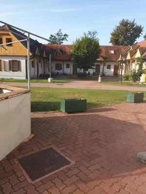 a brick courtyard with houses in the background at Marjetica20 in Moravske Toplice