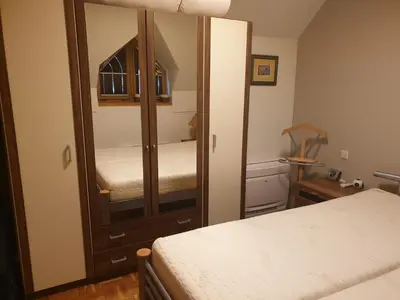 a small bedroom with a mirror and a bed at Marjetica20 in Moravske Toplice