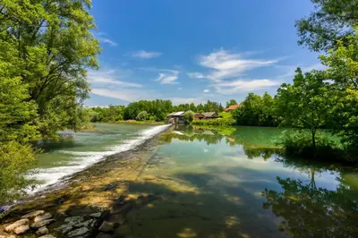 a river with trees and houses in the distance at Tailors House - Happy Rentals in Gradac